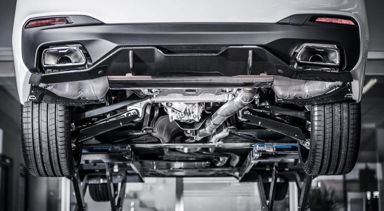 Modern car maintenance on a lift showing vehicle undercarriage