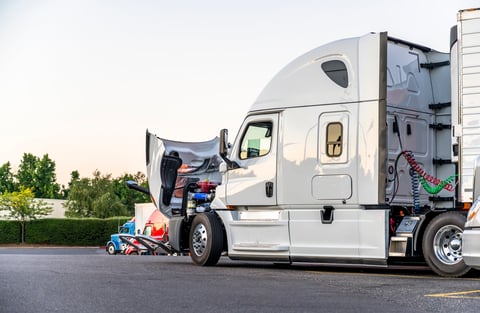 White bonnet big rig semi truck with open hood for engine inspection