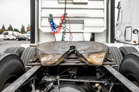 Fifth wheel coupling lubricated on semi truck rear suspension with axles and wheels