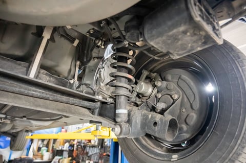 Shock spring under a car tire